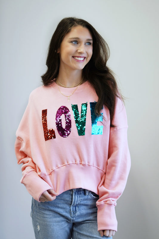 Malibu Pink Sequin "Love" Top Crew Neckline Long Cuffed Sleeve Malibu Pink Base Color Sequin Multicolored "LOVE" Lettering Cuffed Hem Relaxed Fit Full Length 60% Cotton, 40% Polyester