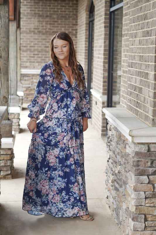 Beautiful Days Blue Floral Maxi Dress V-Neckline Long Cuffed Peasant Sleeves Tiered Ruffle Design Color: Navy w/ Pastel Floral Design Fitted Bodice and Relaxed Skirt Fit Maxi Length 100% Polyester