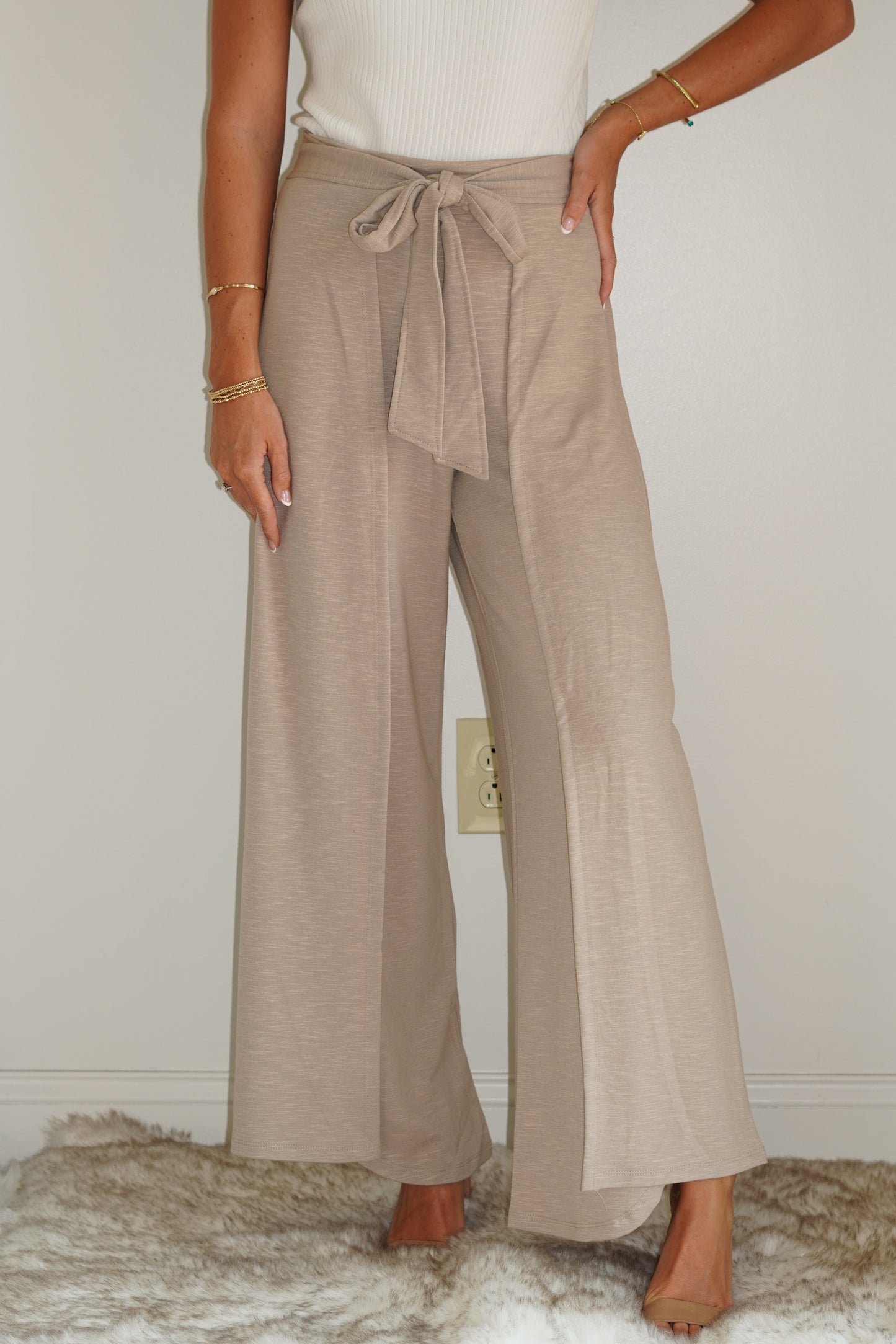 These Sadie Slub Knit Pants are so unique and such an essential to have in your closet this summer! Dress them up or down, these pants will have you looking so stylish!  Sadie Slub Knit Pants Elastic back waist band, and Self Tie Slit Detail 60% Polyester, 35% Rayon, 5% Spandex