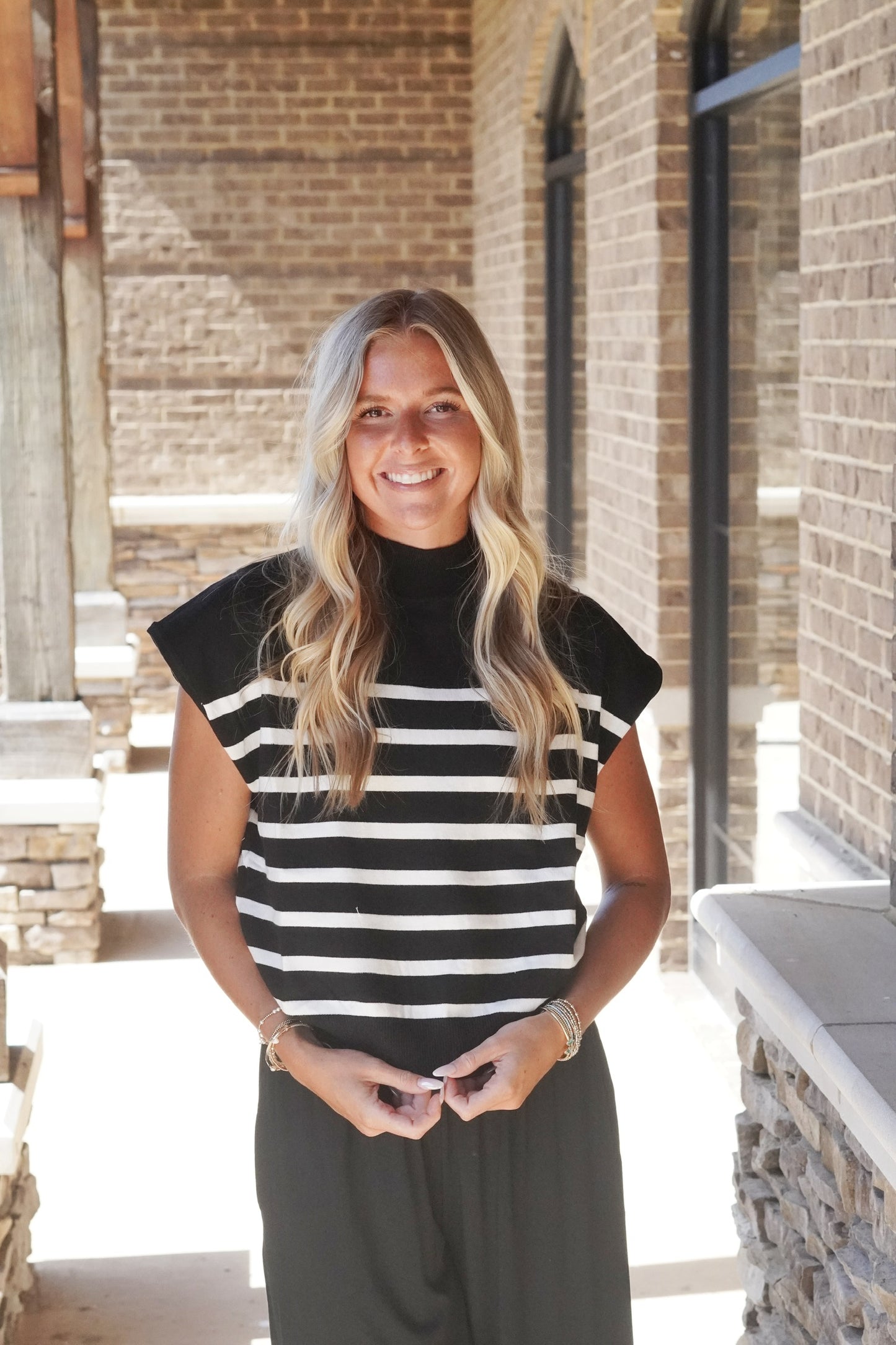 Charlotte Striped Mock Neck Top Mock Neckline Short Sleeves Striped Knit Material  Relaxed Fit Full Length 44% Viscose, 28% Nylon, 28% Polyester black with white stripes