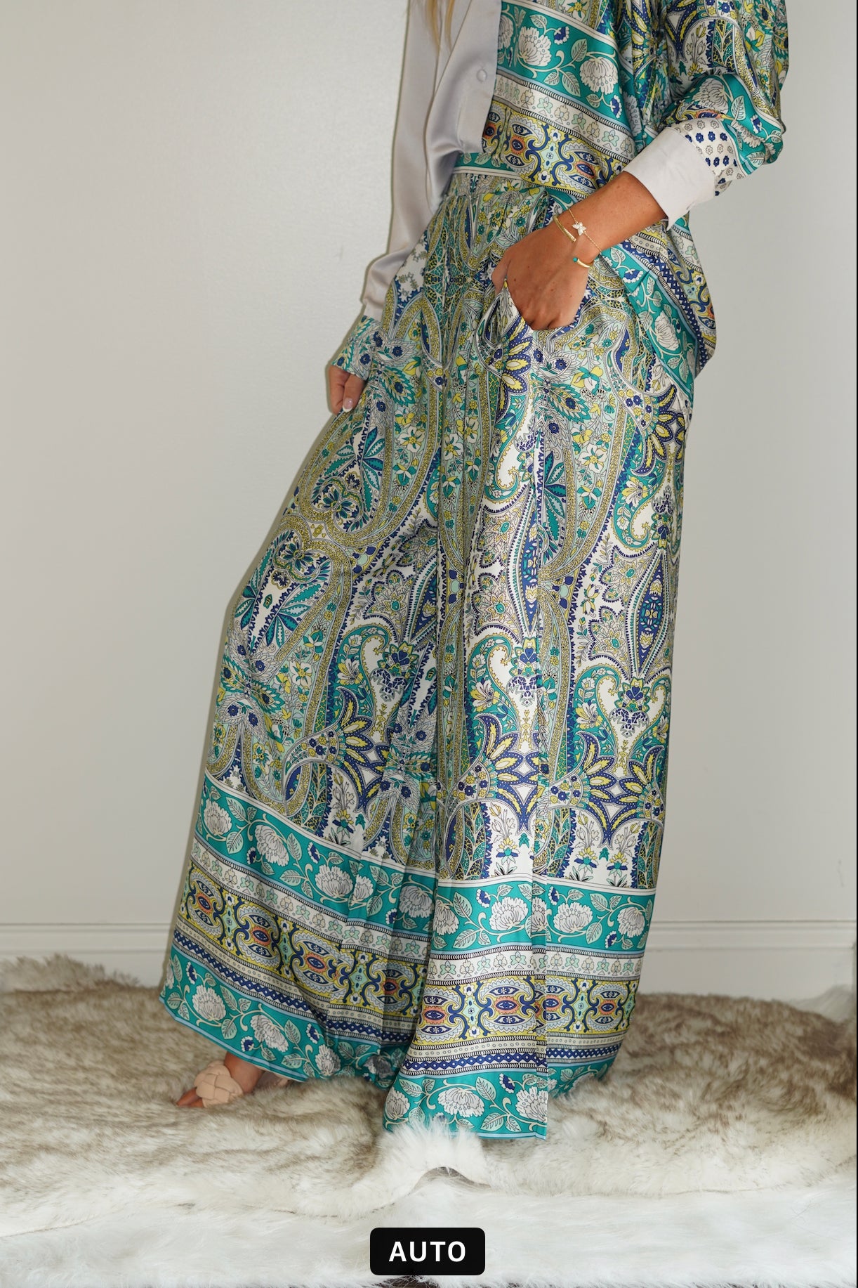 Paisley Satin Print Wide Leg Pants Elastic band on back of waistline Wide Leg Satin Material Teal Printed Pants Fitted waistband, Pants length comes to below the ankles. 100% Polyester Hand wash cold, do not bleach. Hang or line dry. Model is wearing size Small