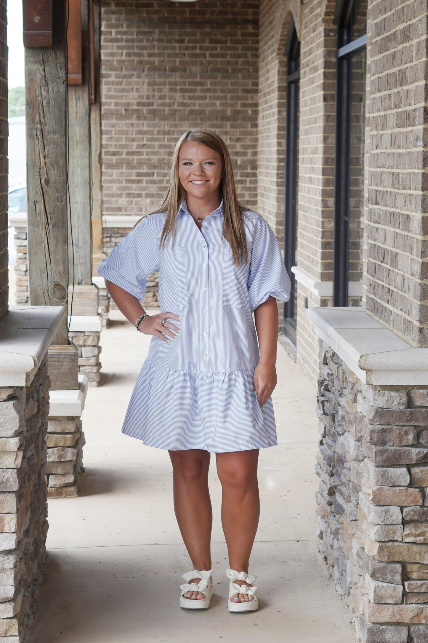 Shelly Striped Puff Sleeve Dress Collared Neckline Button Down Feature Short Puff Sleeves Color: Blue w/ White Striped Ruffle Tiered Bottom Front Pockets Mid-Thigh Length Relaxed Fit 70% Cotton, 30% Polyester