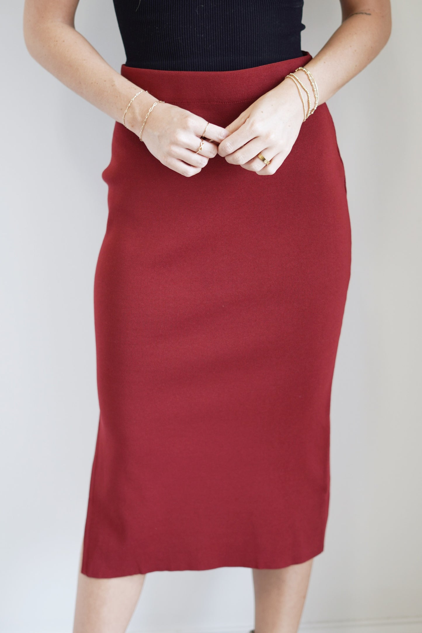 Neely Knitted Midi Skirt Elastic Waistband Fitted Side Slits Carmine Red Color Midi Length 60% Polyester, 40% Viscose Care: Hand wash cold water separately, Do not bleach, Reshape and dry flat, Low iron if needed