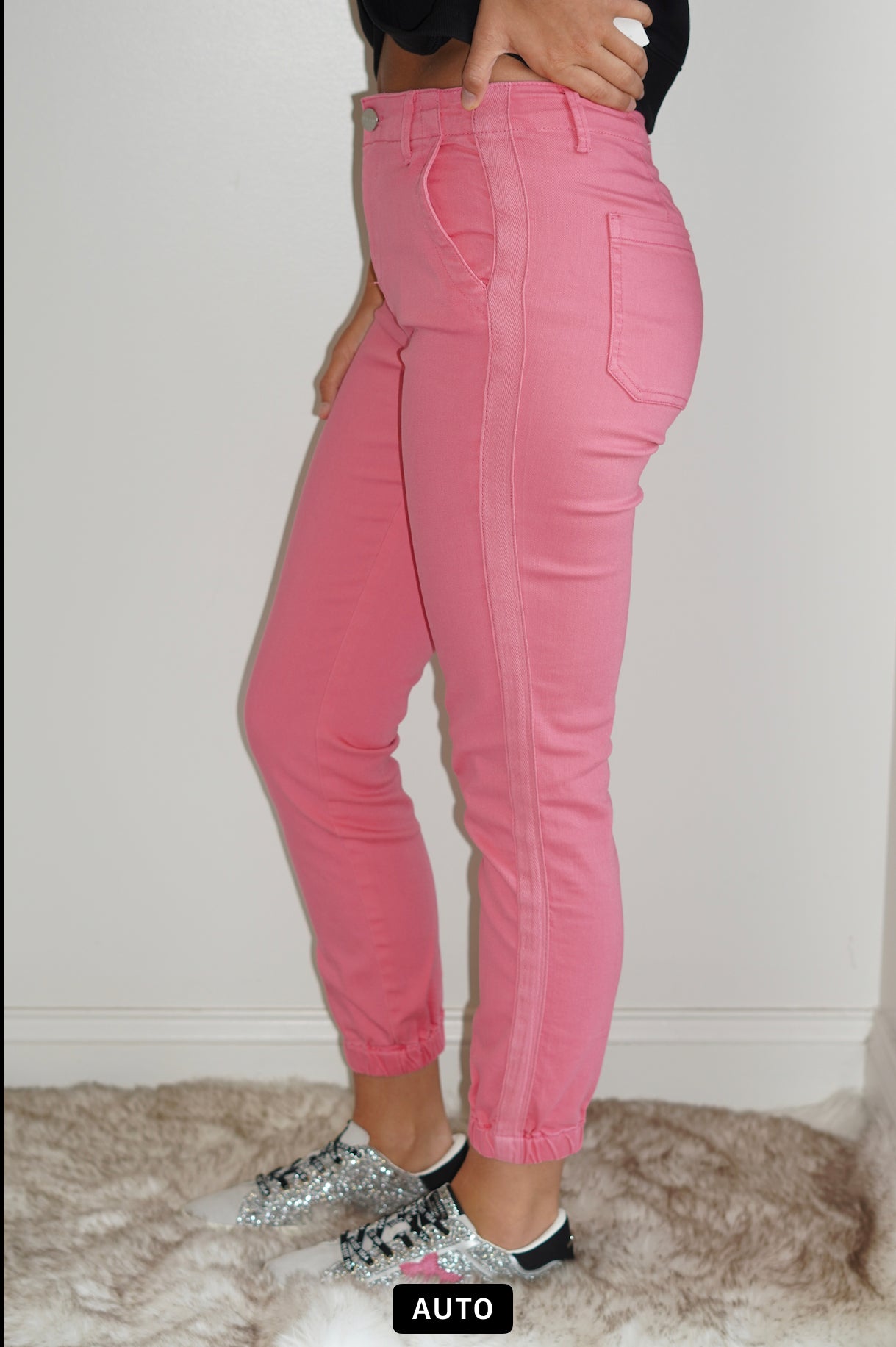 Belle High Rise Pink Jogger Jeans Cuffed Ankle  Pink Line Detail Down the side Button and Zipper Closure  Front and Back Pockets 92% Cotton 6% Polyester  2% Spandex Turn inside out, Machine wash cold, tumble dry low, gentle cycle with colors, Do not bleach, hang to dry, Indigo will bleed, iron if needed  Model Wearing Size 1