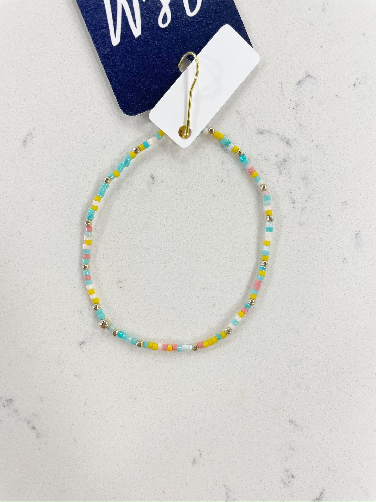 vibrant blue, yellow, pink, white, and gold beaded bracelet