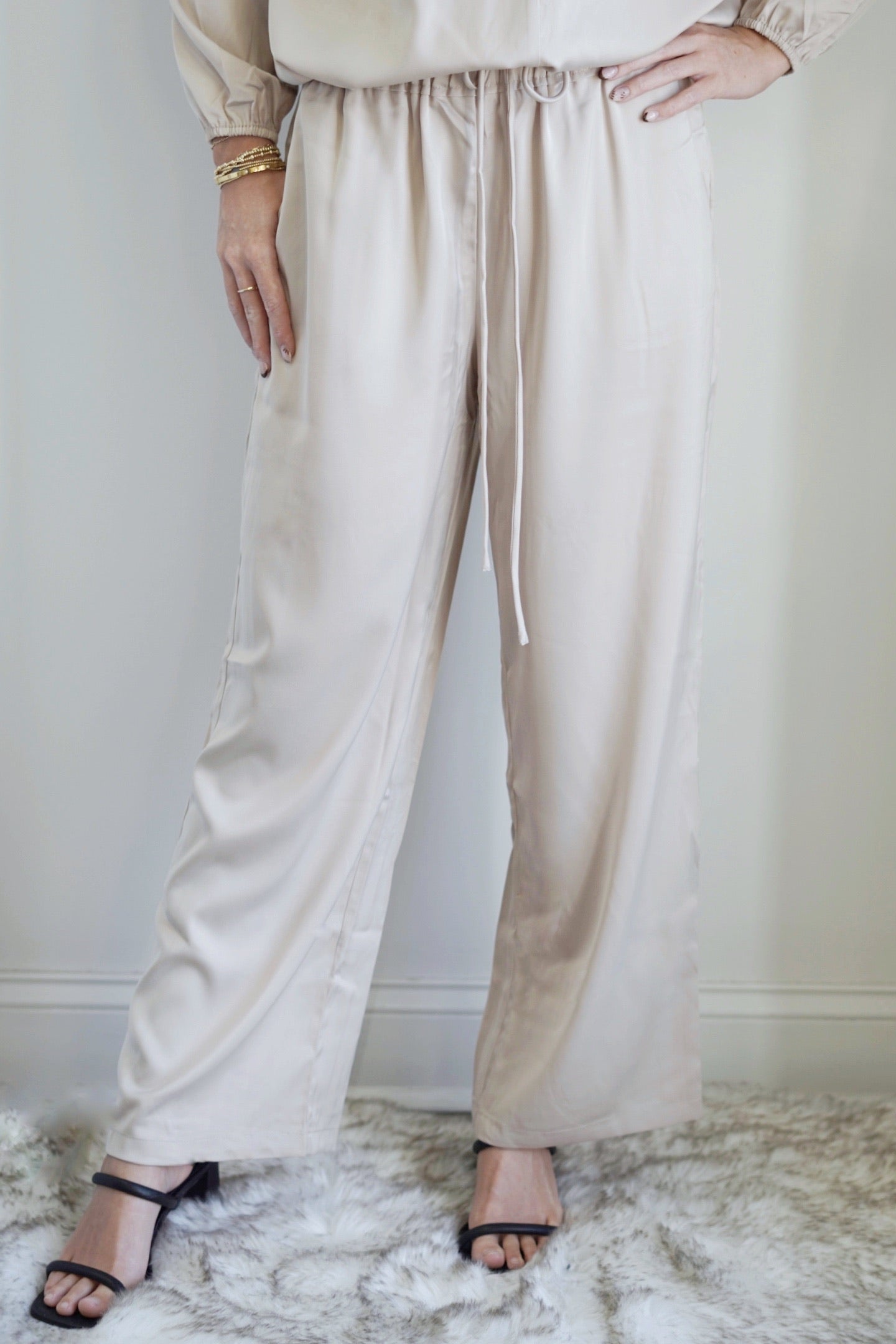 See Me in Satin Cropped Pant Elastic Waistband High Waisted Colors: , Cream Cropped Length Loose Fit Pockets 100% Polyester