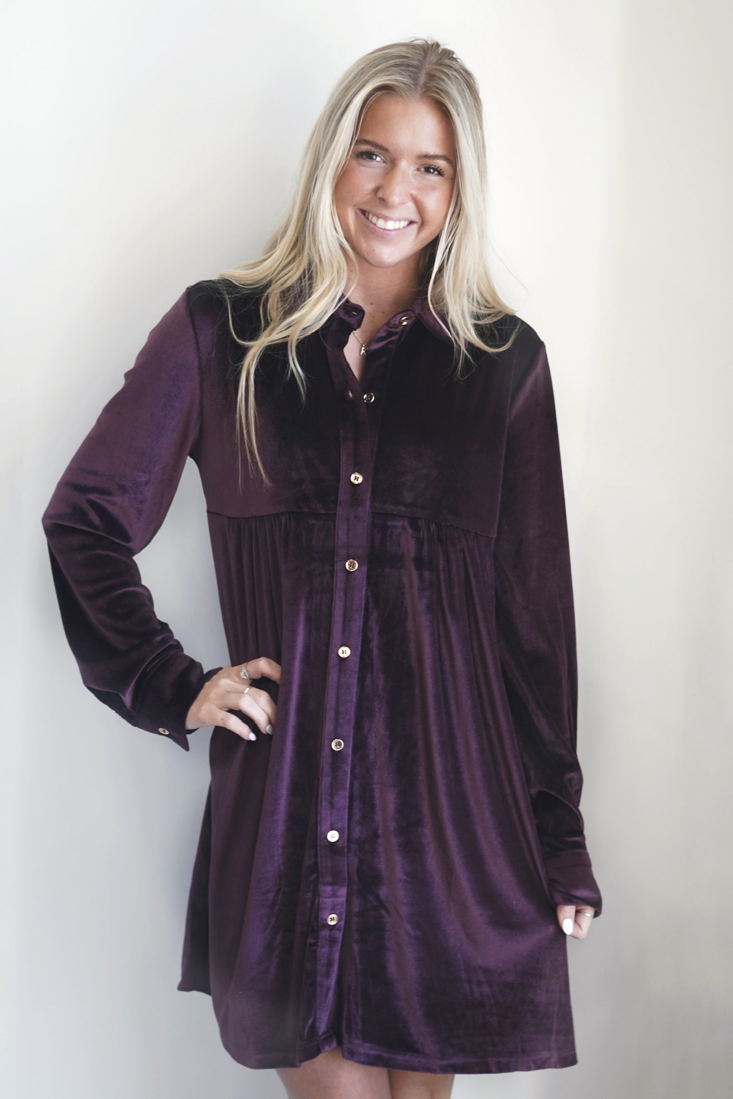 Top Tier Velvet Amethyst Dress Collared Neckline Long Cuffed Sleeves w/ Button Closure Button Down Closure Knee Length Straight Relaxed Fit Color: Amethyst 95% Polyester, 5% Spandex