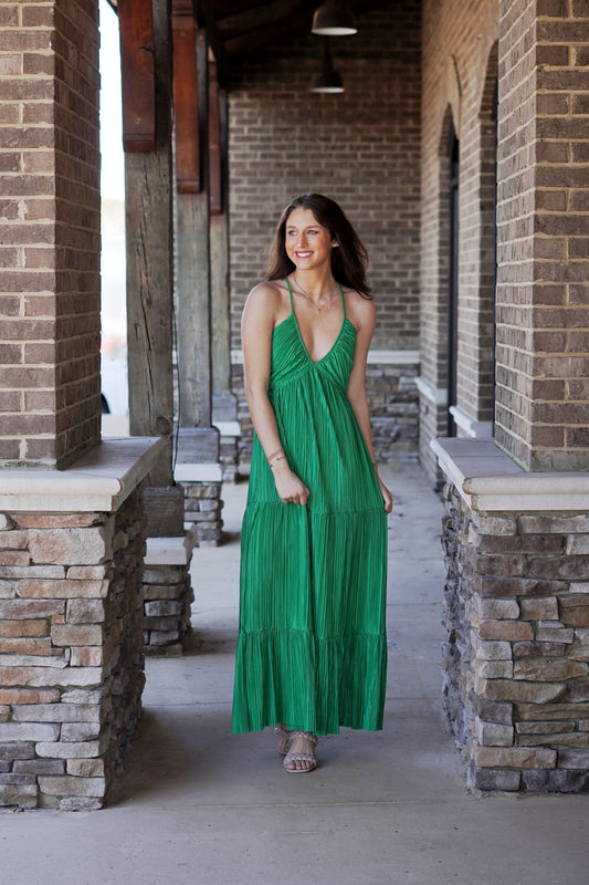 Take Me Out Satin Pleated Maxi Dress V-Neckline Sleeveless Color: Kelly Green Adjustable Spaghetti Straps Satin Pleated Material Open Back Tiered Style Relaxed Fit Maxi Length 100% Polyester