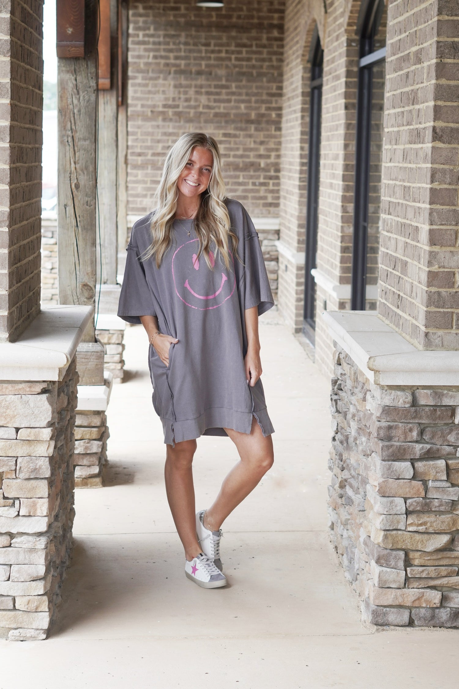 All Smiles T-Shirt Dress Crew Neckline Short Sleeves Color: Charcoal w/ Pink Smiley Face Graphic Oversized Fit Knee Length Pockets Inside out hem detail 65% Cotton, 35% Polyester