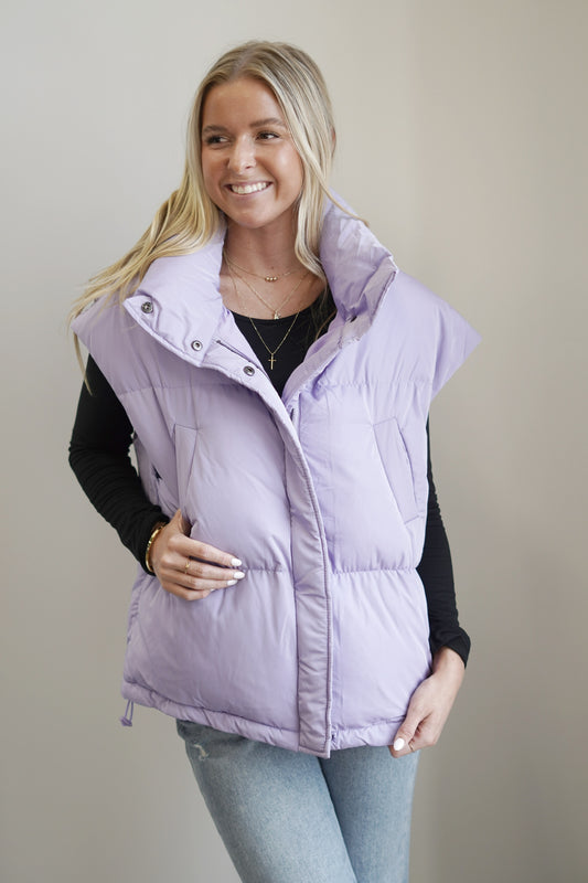 Lola Lavender Oversized Puffer Vest Collar Neckline Button and Zipper Closure Color: Lavender Front Pockets Oversized Fit 100% Polyester