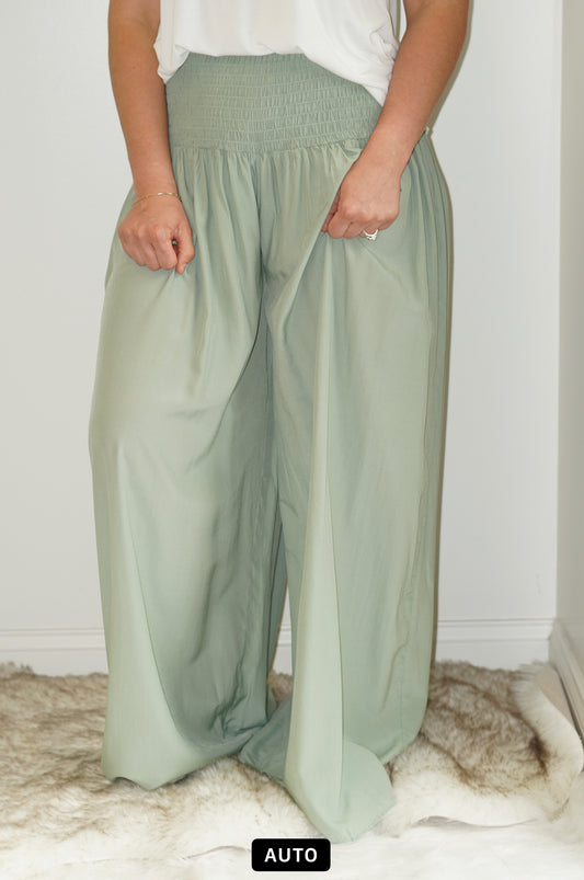 Dani Lush Sage Palazzo Pants Smocked waist  Flows Color: Sage Green  75% Rayon, 25% Polyester  Hand wash Cold, Do not bleach, line dry, Iron on low