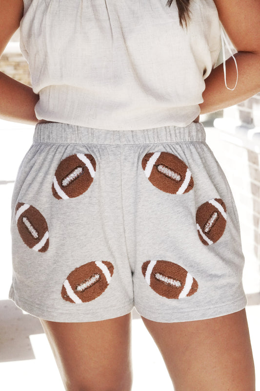 Friday Night Football Sequin Shorts Elastic Waistband Inseam: 2 1/2" Sequin Footballs Pockets Color: Grey Relaxed Fit Fabric Content: 60% Cotton, 40% Polyester