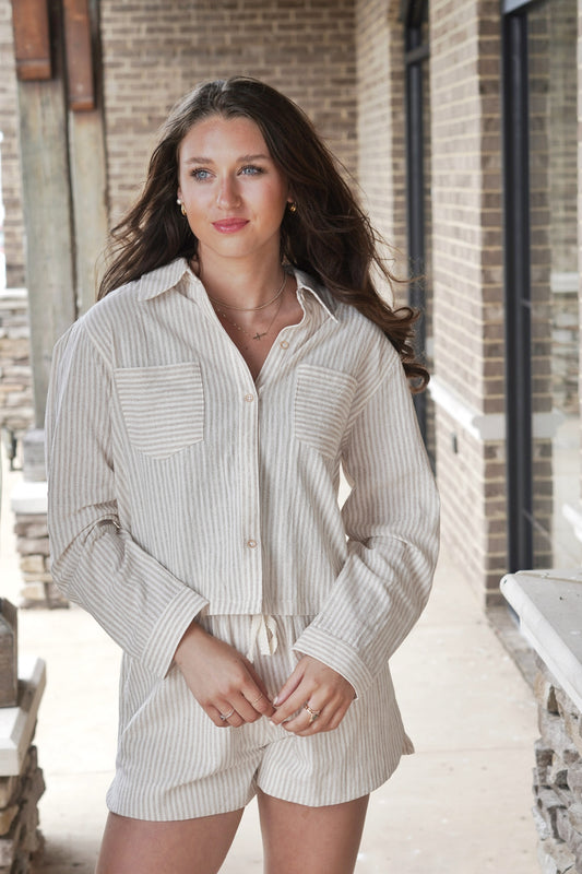 Sail Away Striped Button Up Top Collared Neckline Long Cuffed Sleeves Button Up Feature Color: Natural and White Striped&nbsp; Front Pockets Sleeve Buttons for Easy Rolling Up of the Sleeves Skimmer Length Relaxed Fit 80% Cotton, 20% Linen