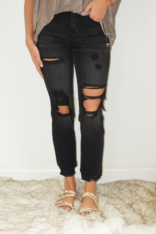 Kat Mid-Rise Crop Boyfriend Jean Color- Black Distressed Holes Distressed Bottom 65% Cotton 32% Polyester 1.5% Viscose 1.5% Spandex Turn inside out, Machine wash cold, tumble dry low, gentle cycle with colors, Do not bleach, hang to dry, Indigo will bleed, iron if needed  Model is wearing size 1