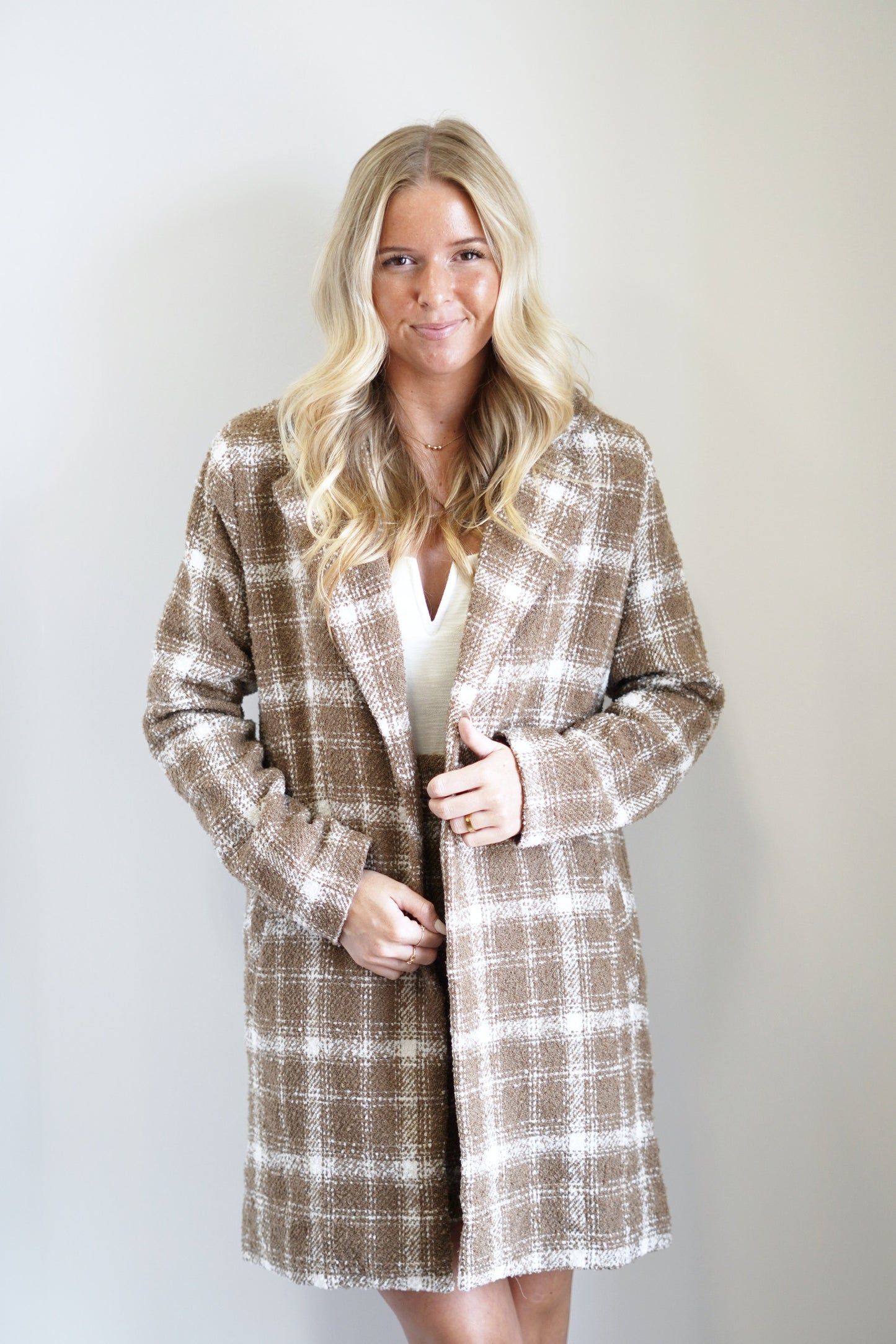 Belle Boucle Plaid Long Coat Collared Neckline Long Sleeves Boucle Material Cream and Brown Plaid Color Oversized Fit Mid-Thigh Length 100% Polyester Care: Dry Clean Only