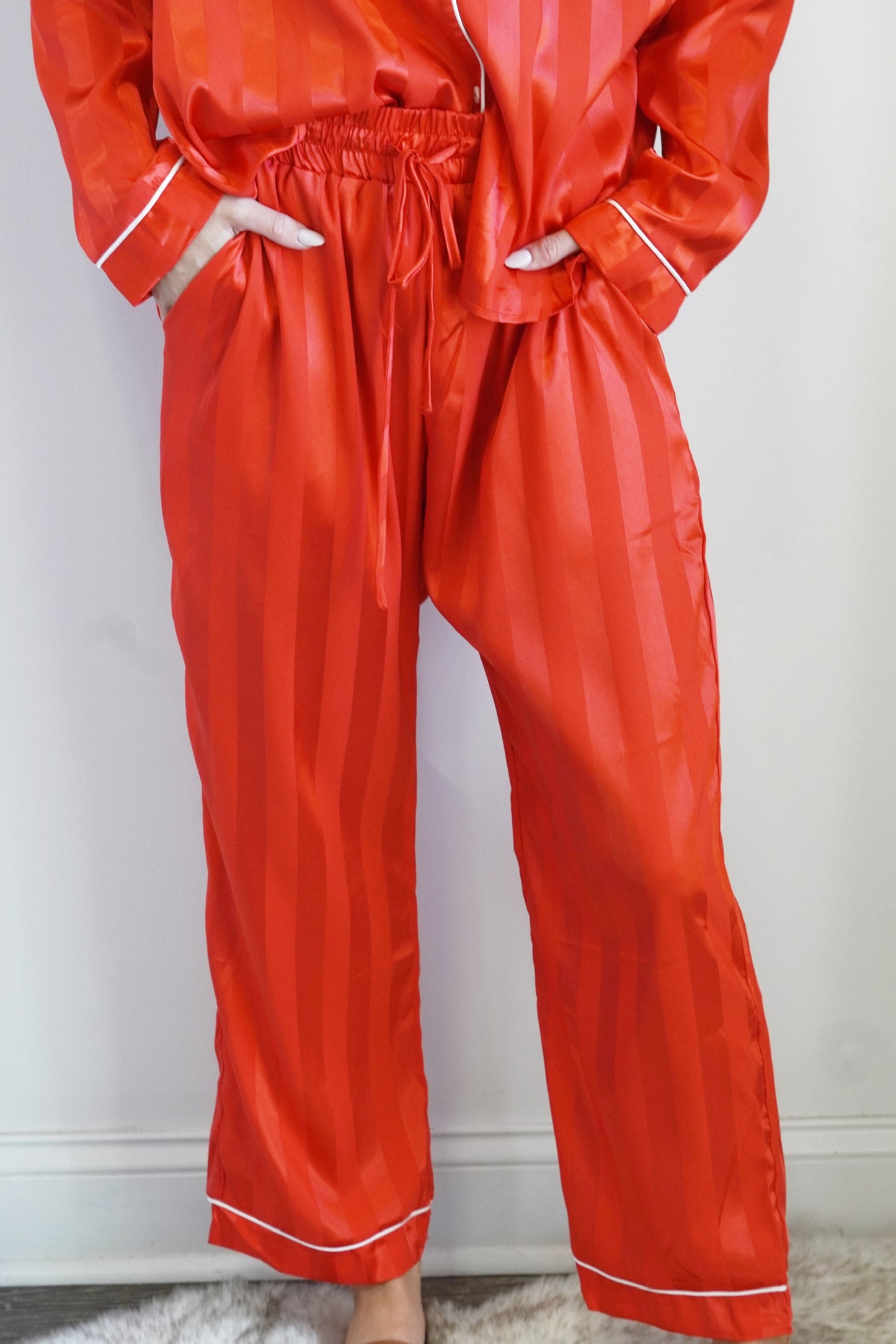 Elastic Waistband w/ Drawstring Two Toned Stripes Colors: Red, White Trim Full Length Pants Relaxed Fit 100% Polyester  