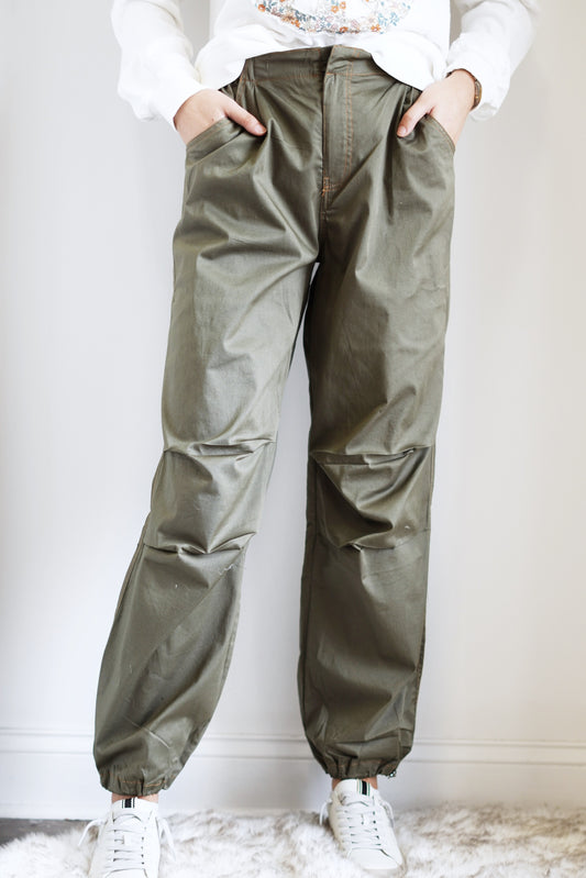 Polly Parachute Jogger Pants Elastic Waistband w/ Zipper Fly and Button Closure Full Length Legs Cinched at the Ankle Pockets Dark Olive Color 97% Cotton, 3% Spandex Care: Hand wash cold, Do not bleach, Dry flat