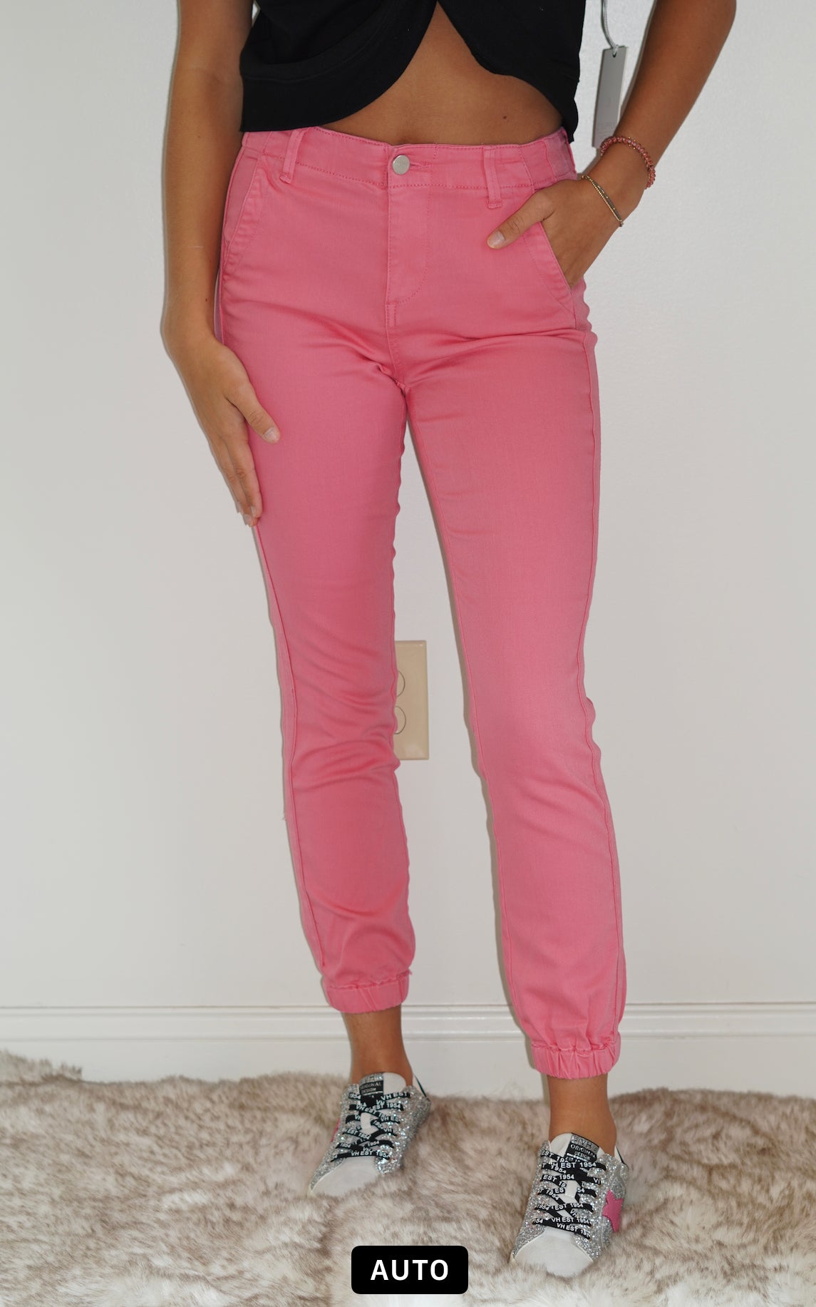Belle High Rise Pink Jogger Jeans Cuffed Ankle  Pink Line Detail Down the side Button and Zipper Closure  Front and Back Pockets 92% Cotton 6% Polyester  2% Spandex Turn inside out, Machine wash cold, tumble dry low, gentle cycle with colors, Do not bleach, hang to dry, Indigo will bleed, iron if needed  Model Wearing Size 1