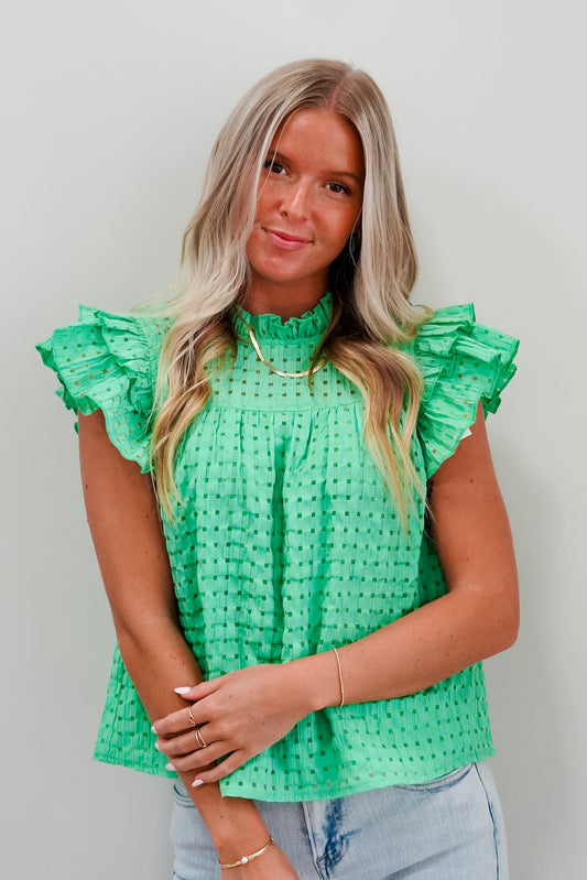 Brittney High Neck Eyelet Flutter Sleeve Blouse Checkered Eyelet Pattern  Flutter Sleeves 46% Polyester  44% Cotton 10% Nylon Hand Wash Cold, Colors Will Bleed, No Bleach, Do Not Tumble Dry 