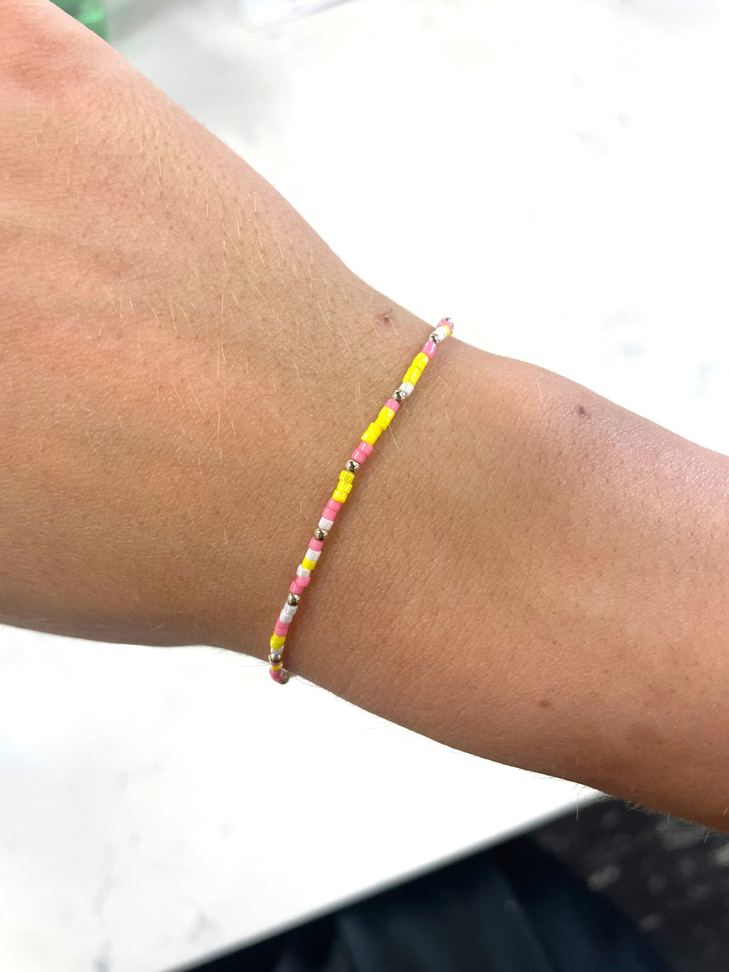 bright pink, yellow, white, and gold small beaded bracelet