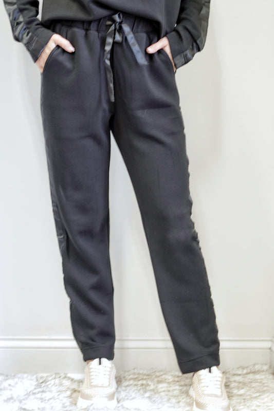 So Sleek Satin Trim Athletic Pant Mid Waisted Elastic Waistband with Tie Satin Trim Detail on Side of Legs Colors: Black, Tapered Pant  Ankle Length Relaxed Fit 48% Modal, 46% Polyester, 6% Spandex