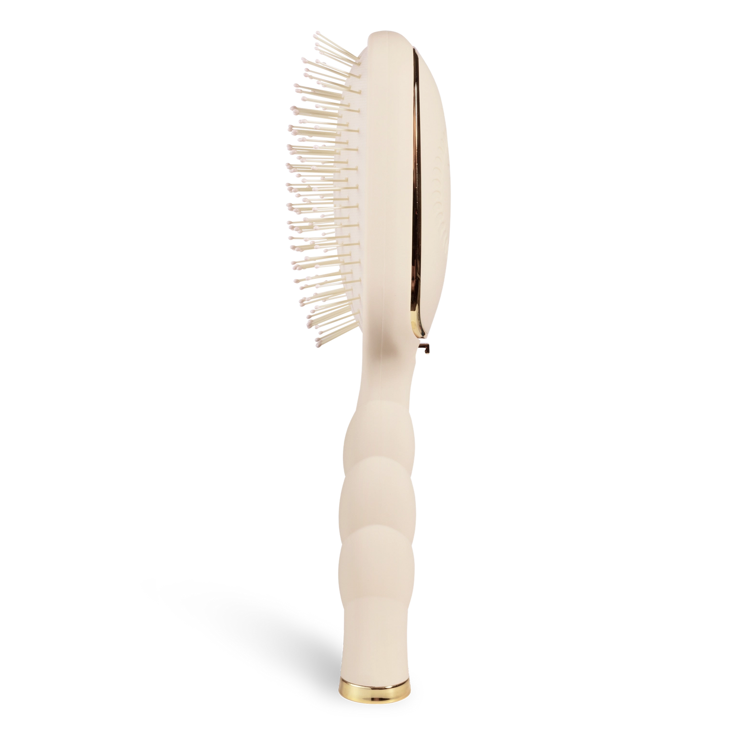 Oval hair brush, beige handle, gentle glide bristle, textured handle with gold trim shown from the side. 