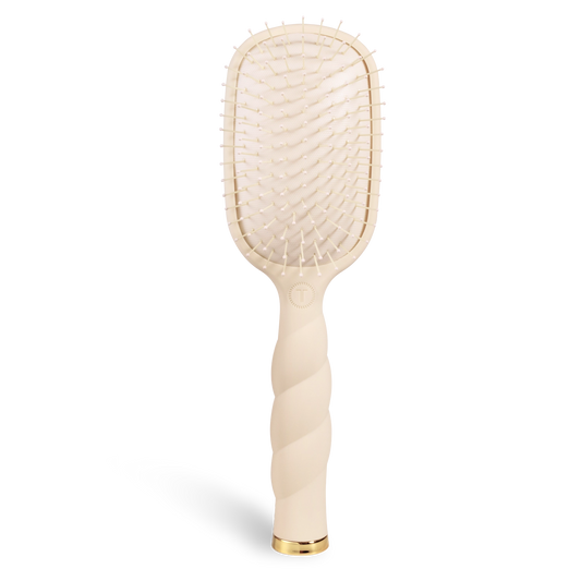 Oval hair brush, beige handle, gentle glide bristle, textured handle with gold trim.