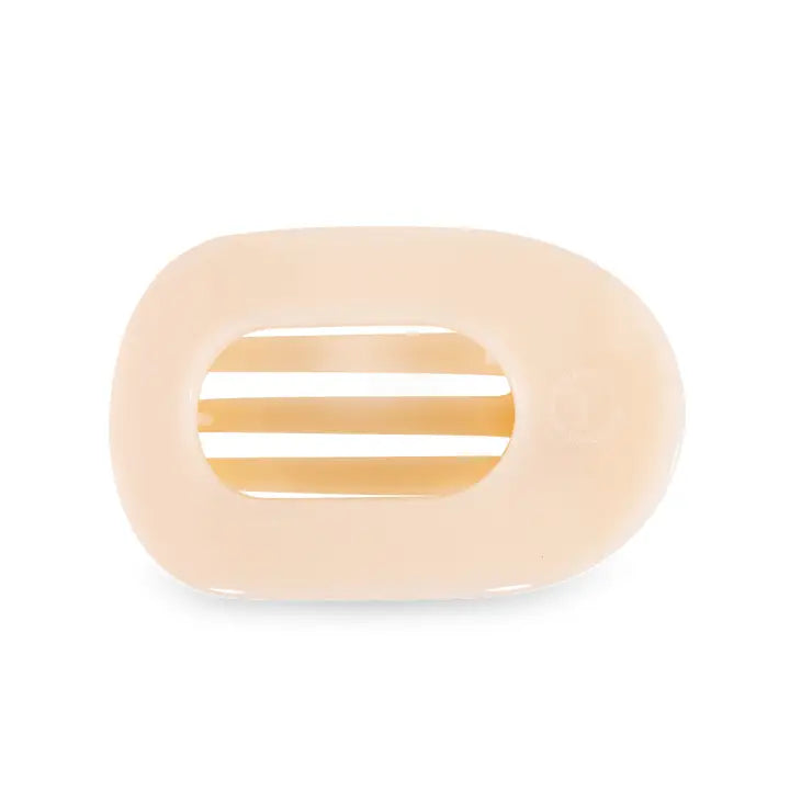 medium sized flat round clip in the color almond biege