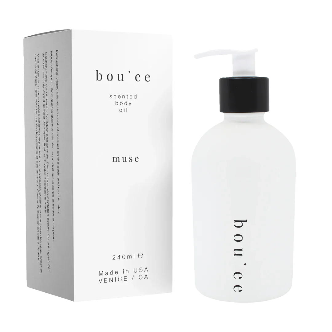 Bou;ee muse scented body oil bottle with pump. next to its matching product box 