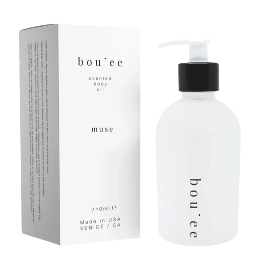 Bou;ee muse scented body oil bottle with pump. next to its matching product box 