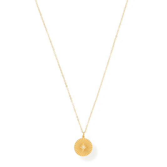 gold necklace with sunburst pendant.