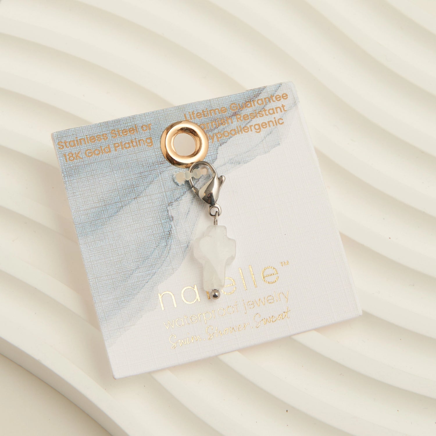 Pearl cross charm with a silver lobster clasp