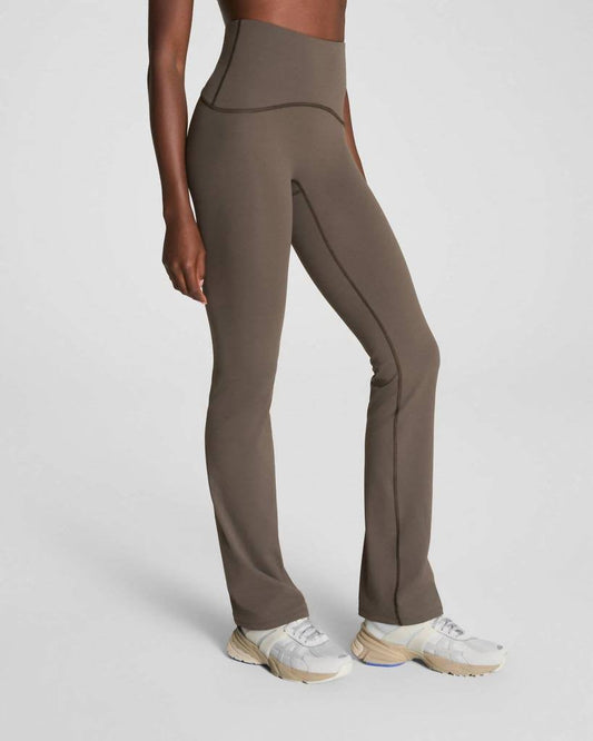 Woman wearing brown high waisted flare leggings