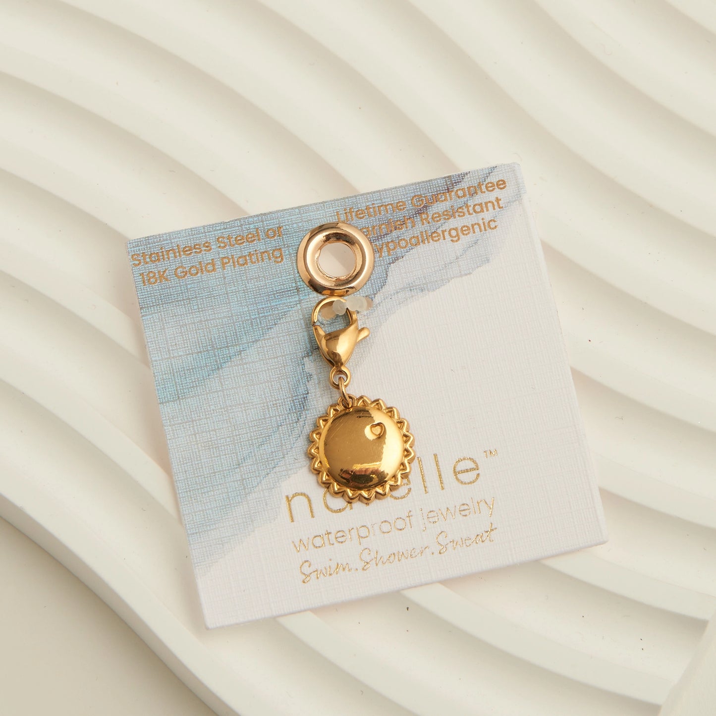 Sun shaped gold charm, with a lobster clap. 
