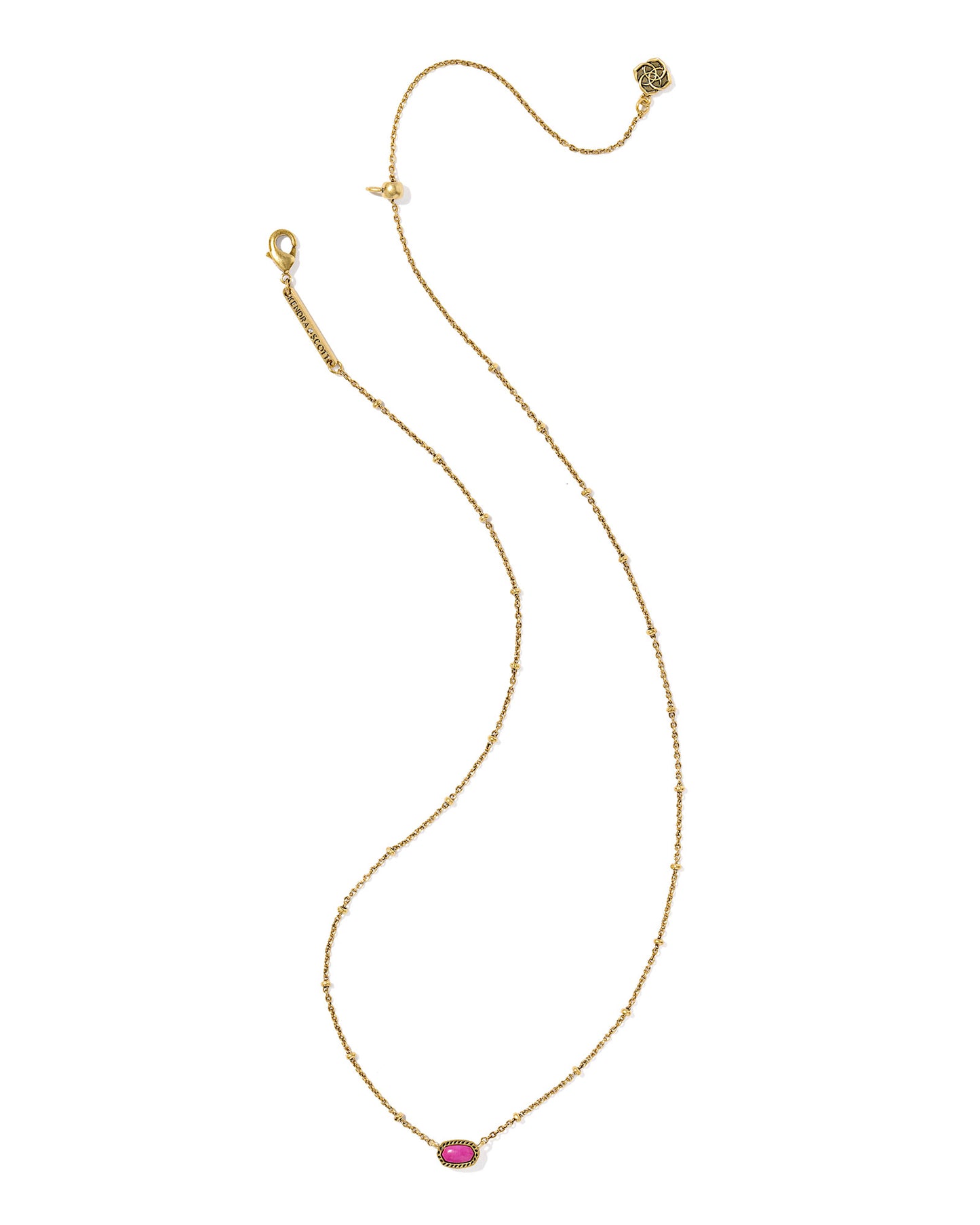 Gold necklace with a oval pink stone pendant, the chain has a small circular details and the pendant is set within a textured gold frame.  