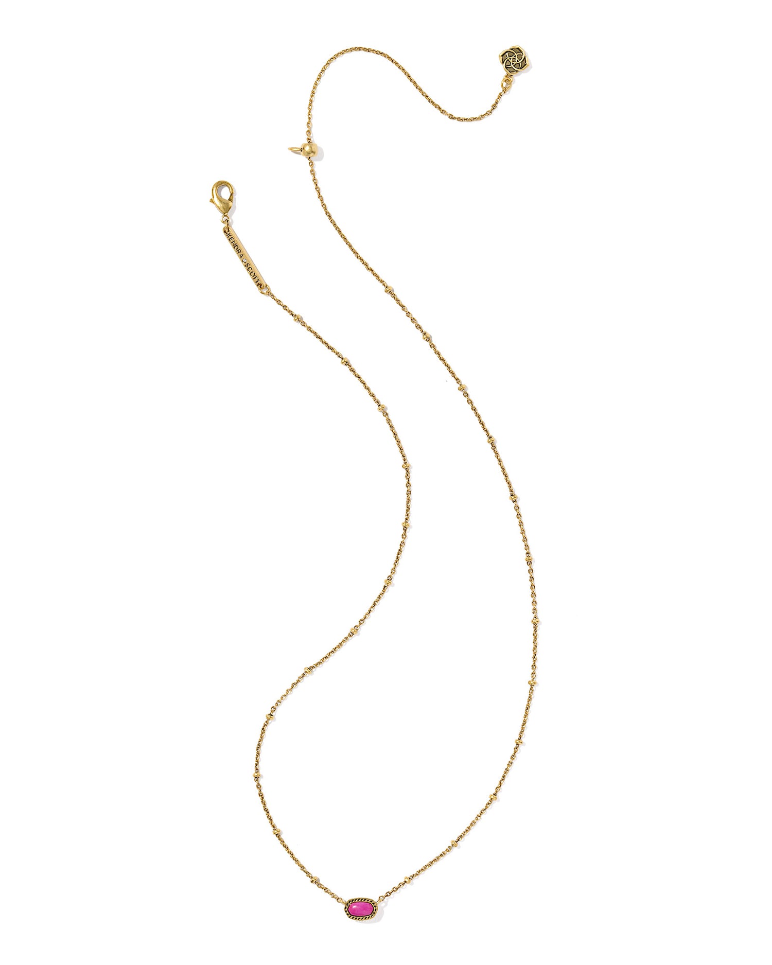 Gold necklace with a oval pink stone pendant, the chain has a small circular details and the pendant is set within a textured gold frame.  