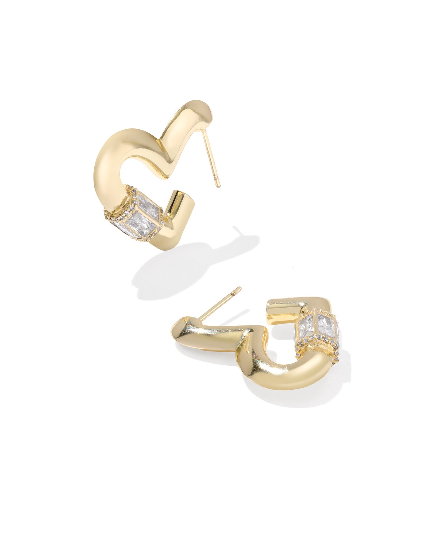 Add some bold romance to your ear stack with the Emery Heart Gold Hoop Earrings. These fun heart-shaped hoops—inspired by our bestselling Ari silhouette—feature a high-shine metal finish and are studded with beautiful baguette stones for extra sparkle.
Metal- 14k Yellow Gold Over Brass
Closure- Ear wire
Size- 1"L X 0.25"W