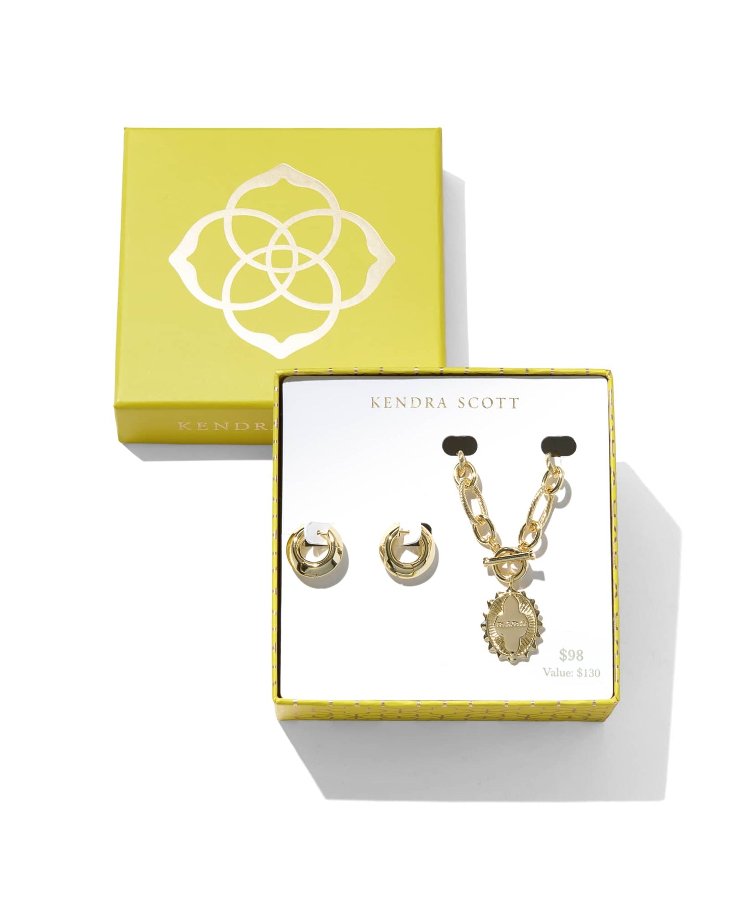 Jewelry set with necklace that has a pendant with the words “mama” engrave in it and gold hoop huggie earrings. 