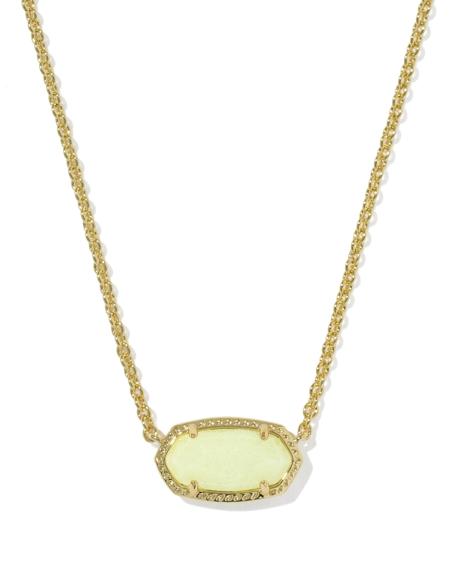 Necklace with a off white pendant on a textured gold frame on a white background
