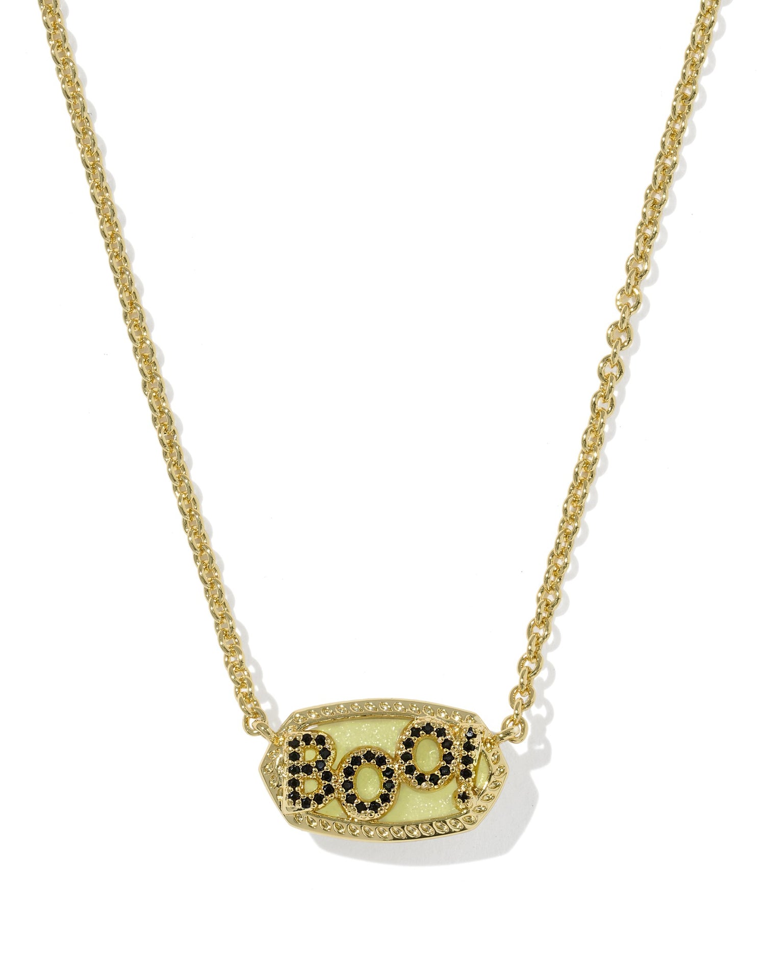 Gold necklace with off white pendant with ‘boo’ in black stone on a white background
