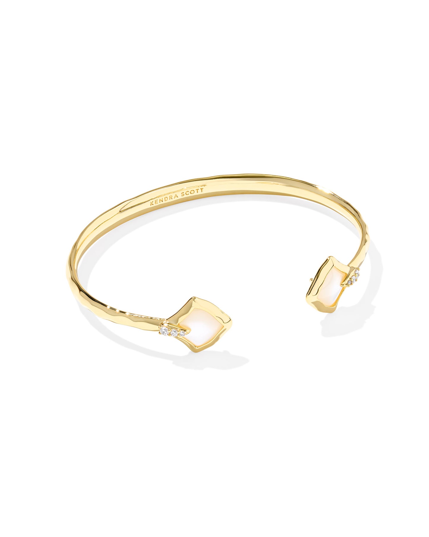 Gold cuff bracelet. Alexandra shaped (diamond shape) ivory mother of pearl at the end of each side.
