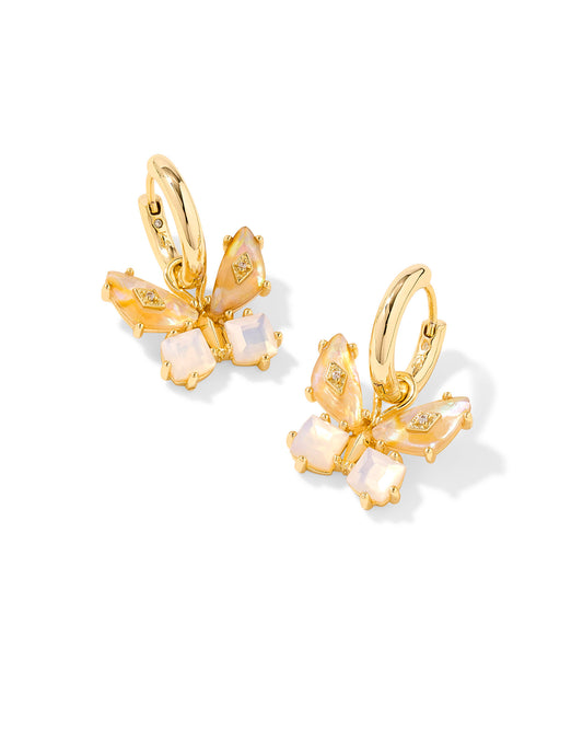 Gold huggie earrings with butterfly pendant. Gold iridescent white mix stones in the shape of a butterfly.
