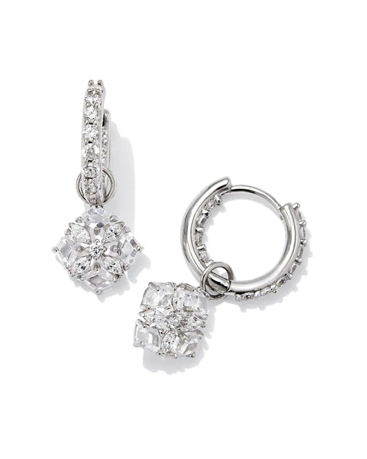silver huggie earrings with white crystal studs and a flower charm that is also crystal studded