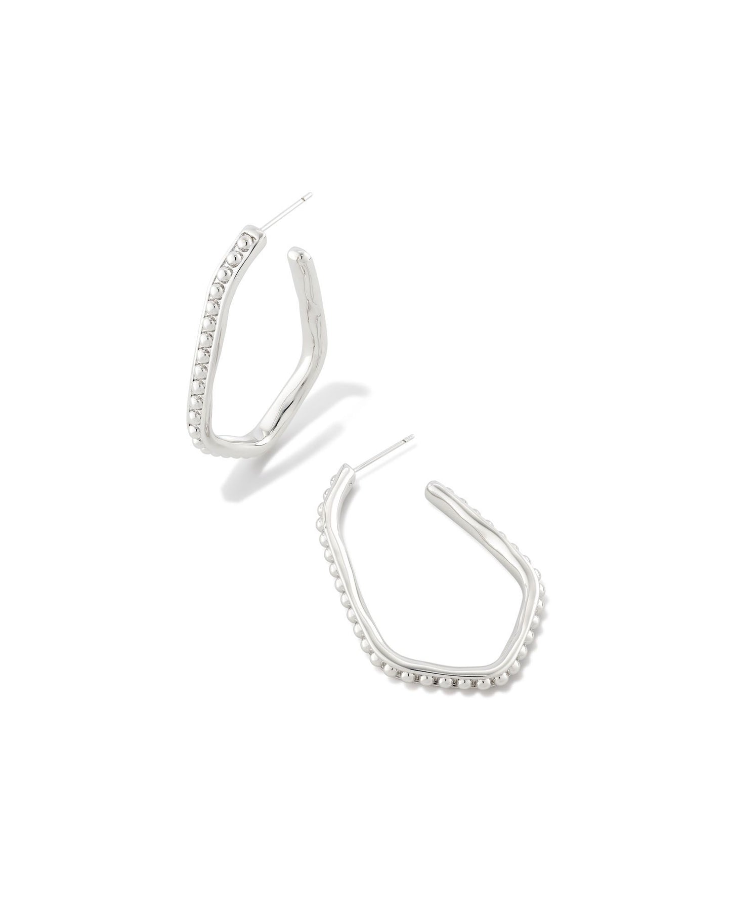 This eye-catching elongated hoop design is perfect for shaking up your look. With textured metal beads and a face-framing shape, the Lonnie Beaded Hoop Earrings in Gold go with any sense of style. These are silver colored. 