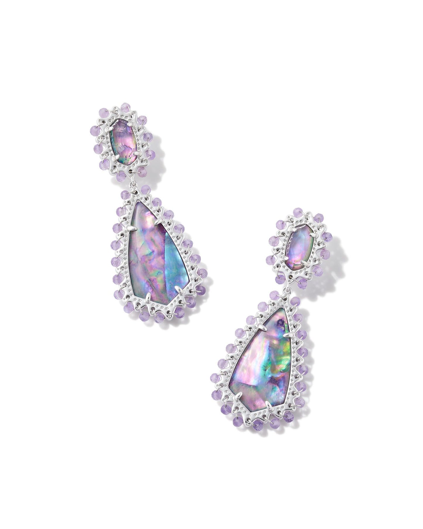 With beads, stones, and iconic brand shapes, the Beaded Camry Statement Earrings in Iridescent Mix really do have it all—grab a pair and get ready to stand out this spring. This metal is 24k rhodium plated over brass with purple beads and iridescent stones. 