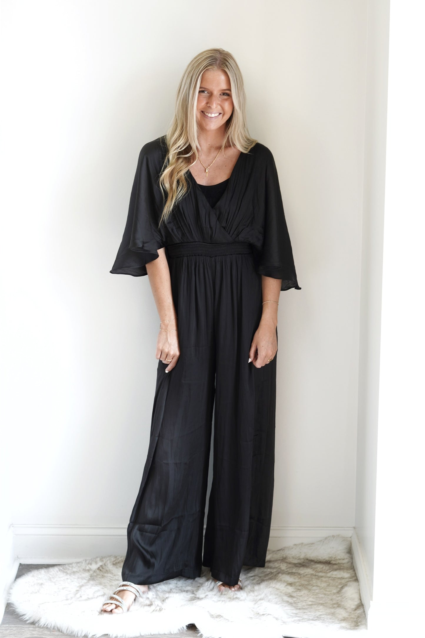 Lilah Wide-leg Jumpsuit V-Neck with Smocked Waist Back Keyhole with Button Closure Caped Sleeve Color: Black Full Length 100% Polyester Dry Clean Only