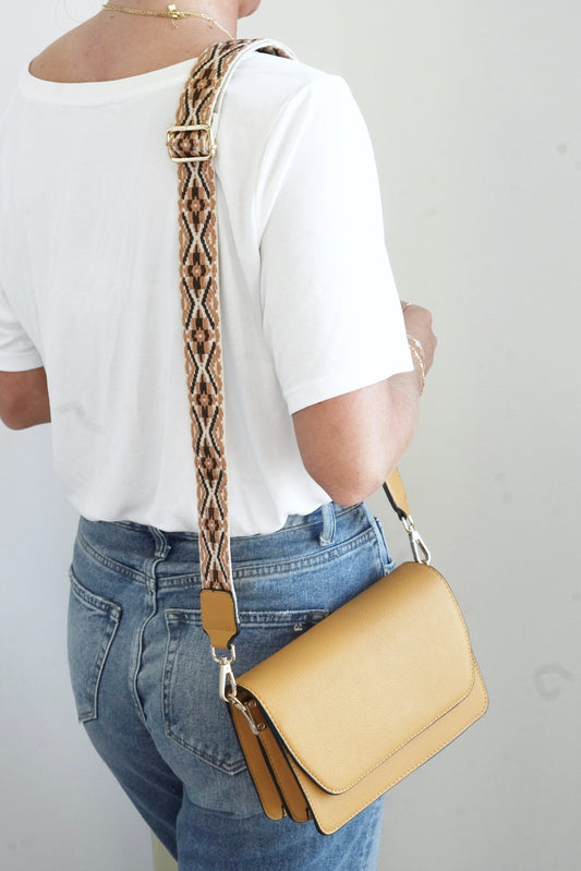 Noah Vegan Leather Crossbody Magnetic Front Flap Two Open Inner Pockets Middle Zipper Pocket Small Inner Zipper Pocket Adjustable Crossbody Guitar Strap Approx. 8 1/2 in x 6 in x 3 in mustard color