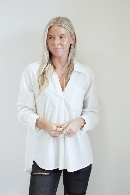 Hilary Active Button Up Collared  Cuff Sleeve Full Button Up with Front Pocket Color: Ivory Full Length 90% Nylon, 10% Spandex Hand Wash Cold, Do Not Bleach, Lay Flat to Dry, Cool Iron if Needed Model is wearing a size Small