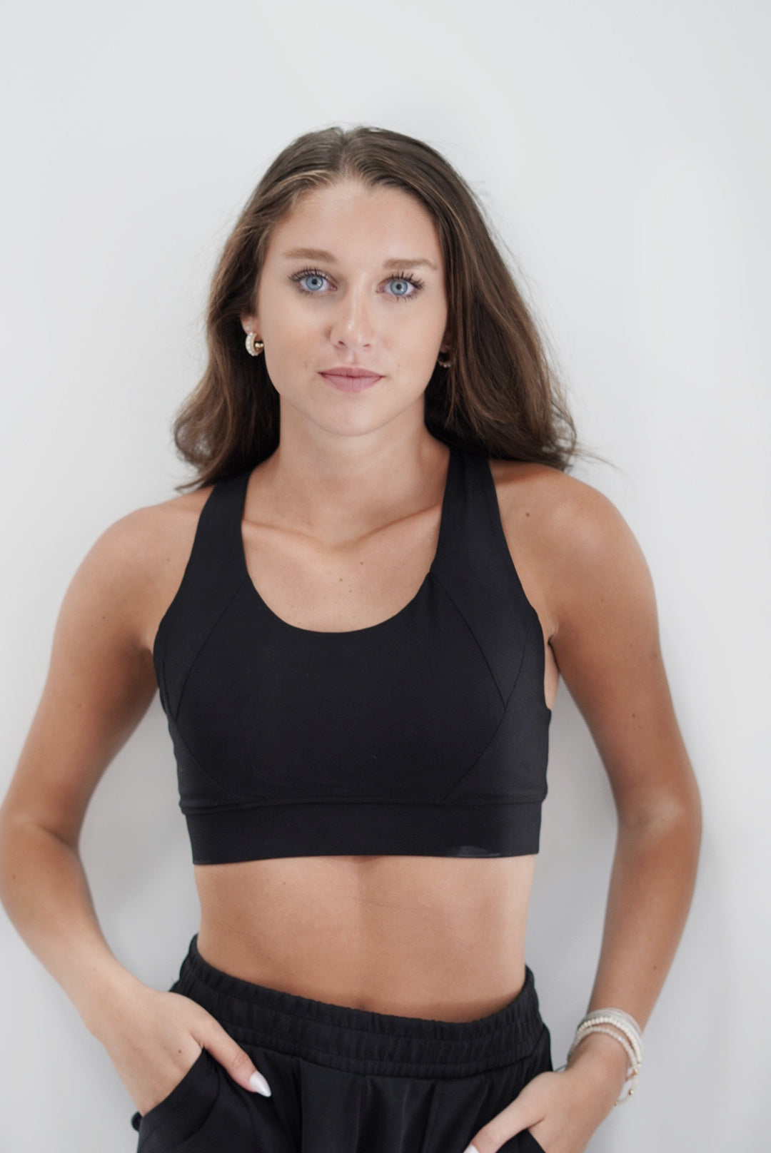 Callie Criss Cross Padded Sports Bra Thick Strap Sleeveless Criss Cross Detail On Back Tight Waistband on bottom of Bra Tighter Fit Color, Black 84% Poly Microfiber, 16% Spandex, Wash with like colors Model is wearing size small 