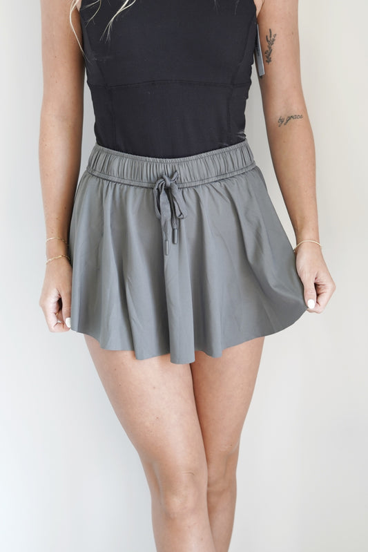 Lexia Lightweight Flowy Skort Elastic Waistline Drawstring  Built In Spandex Shorts Flowy Skirt Charcoal Color 95% Polyester, 5% Spandex Hand Wash Cold, Do Not Bleach, Lay Flat To Dry, Cool Iron If Needed.